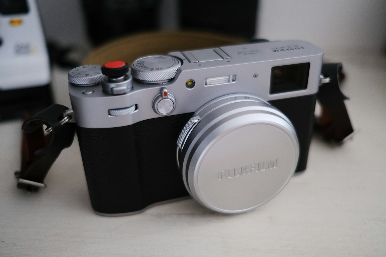 a silver and black camera sitting on top of a table